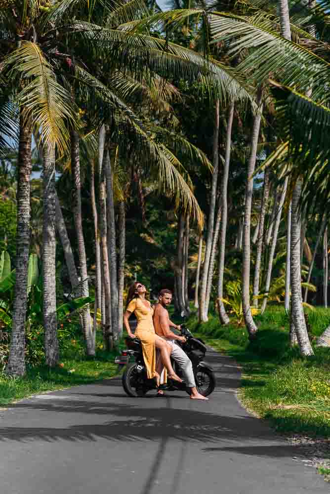 Ampersand resort tour experiences a couple on a motorcycle in thailand among palm trees