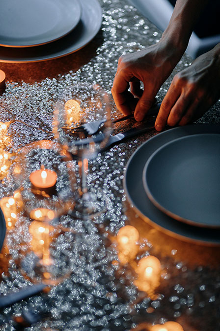 setting plates and utensils for dinner at Ampersand resort bar & restaurant